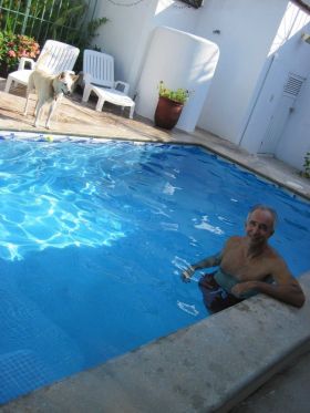 Chuck Bolotin and his dog relaxing at home rental at Lo de Marcos, Mexico