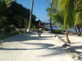 Man riding his bike near the beach in San Pedro, Ambergris Caye, Belize – Best Places In The World To Retire – International Living
