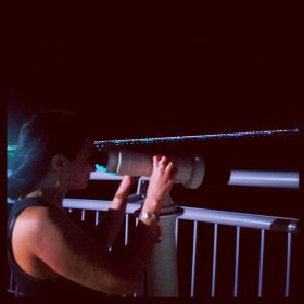 Mary looking through telescope at Coastal Strip in Panama at night – Best Places In The World To Retire – International Living