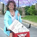 Anne-Michelle Wand Bocas Del Toro, Panana on bike with umbrella – Best Places In The World To Retire – International Living