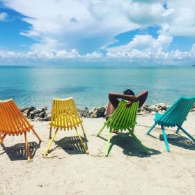 Lounging in beach chairs at Secret Beach, Ambergris Caye, Belize – Best Places In The World To Retire – International Living