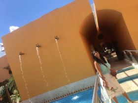 Jet Metier at walkway over pool at Casa de las Venados, Valladolid, Mexico – Best Places In The World To Retire – International Living