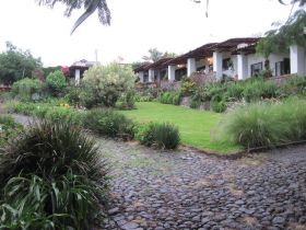 View of large home in Jocotepec, fro driveway through garden – Best Places In The World To Retire – International Living