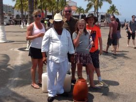 A family enjoying fresh coconut juice on the malecon of Puerto Vallarta, Mexico – Best Places In The World To Retire – International Living