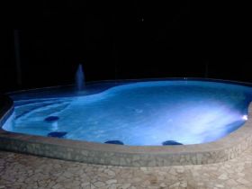 Pool lit at night in Placencia, Belize – Best Places In The World To Retire – International Living