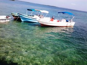 Bocas del Toro Panama boats in shallow water tied to dock with ocean – Best Places In The World To Retire – International Living