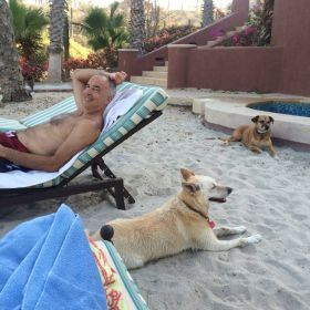 Chuck Bolotin relaxing with two dogs in Baja California Sur