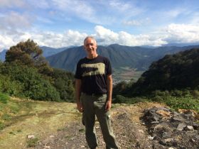 Chuck Bolotin standing in front of mountains between Puebla and Cordoba, Mexico