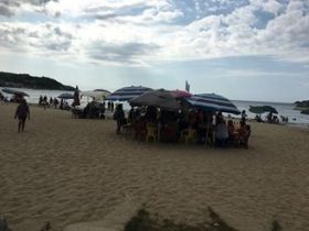 Guayabitos beach, with people under umbrellas