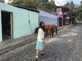 Jet Metier walking on a cobblestone street in Mexico