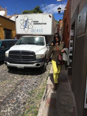 Jet Metier walking down a narrow street in Mexico