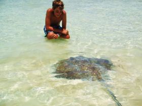 Stingray with boy in Isla Contoy – Best Places In The World To Retire – International Living